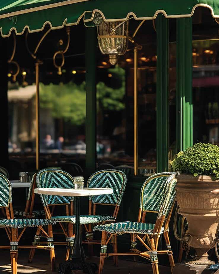 A Mediterranean pavement café with green awnings and woven bistro chairs